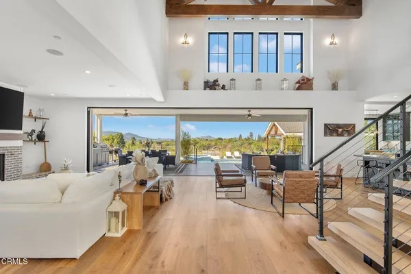 a kitchen with stainless steel appliances kitchen island granite countertop a table chairs and a refrigerator