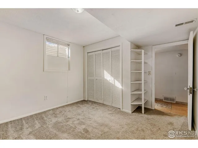 a view of an empty room with a fireplace