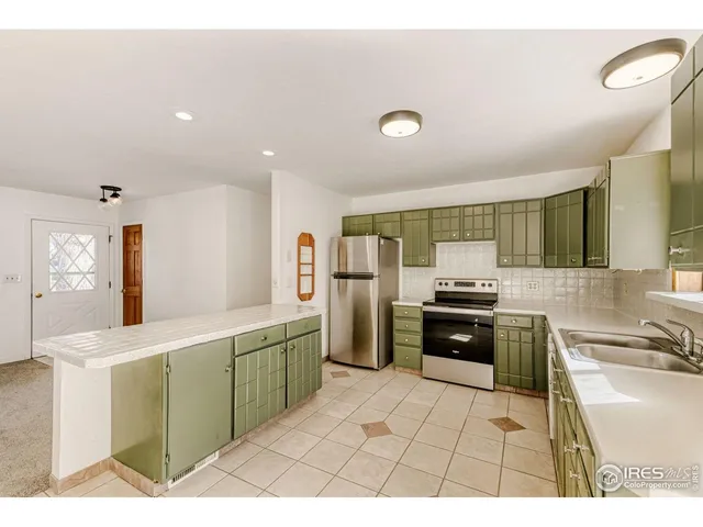 a kitchen with a sink refrigerator and cabinets