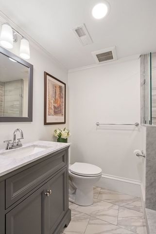 a bathroom with a sink a toilet and mirror