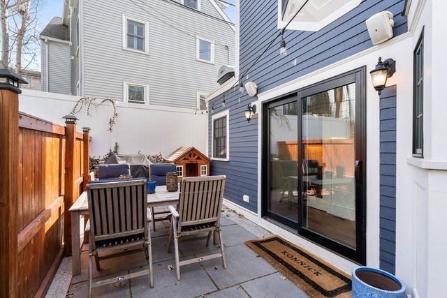 a view of a patio with a table and chairs