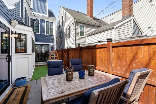 a view of a patio with table and chairs