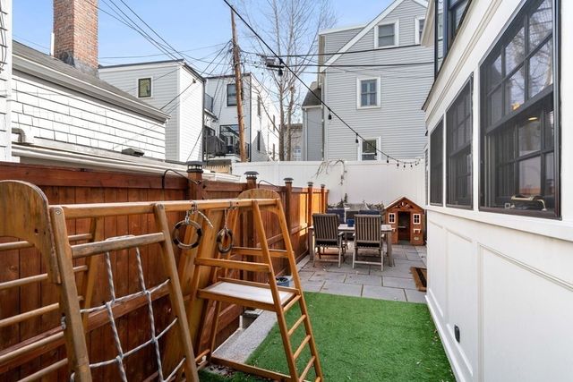a view of a patio with table and chairs