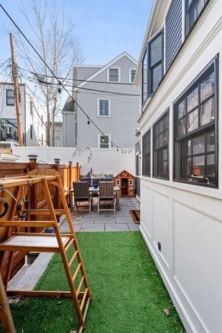 a view of a house with backyard porch and sitting area