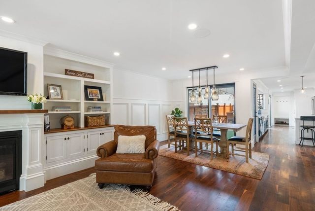 a living room with furniture wooden floor and a flat screen tv