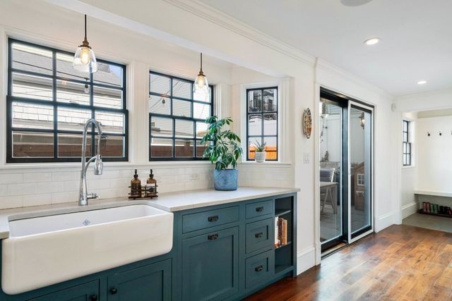 a kitchen with a refrigerator and a sink