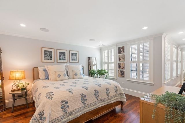a bedroom with a large bed and a large window