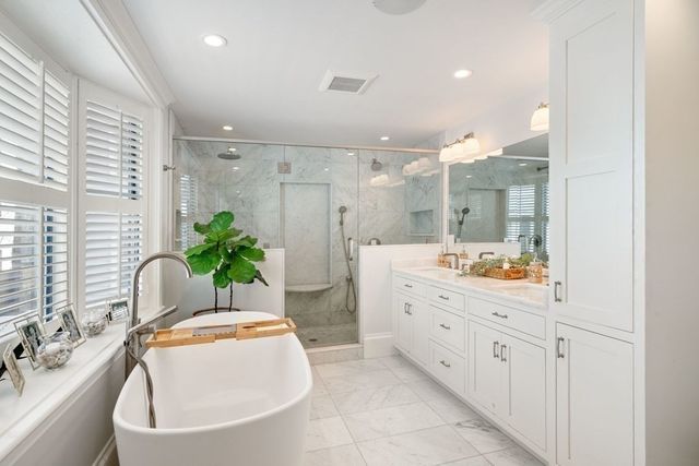 a spacious bathroom with a granite countertop tub sink and mirror