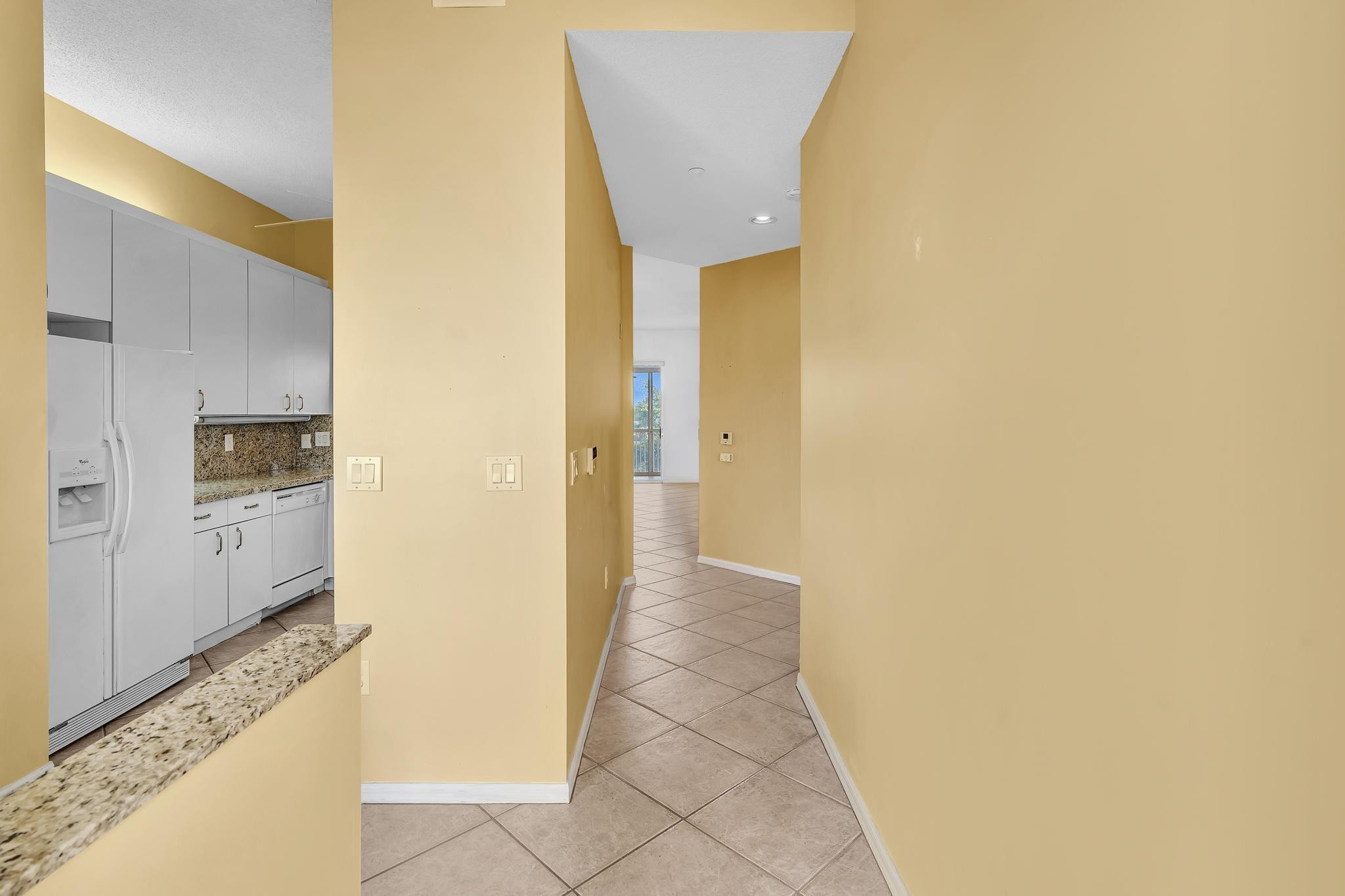 9551 Weldon Circle, Unit E411 Tamarac, FL 33321 - Photo 12 of 78 a view of a hallway with a dining table