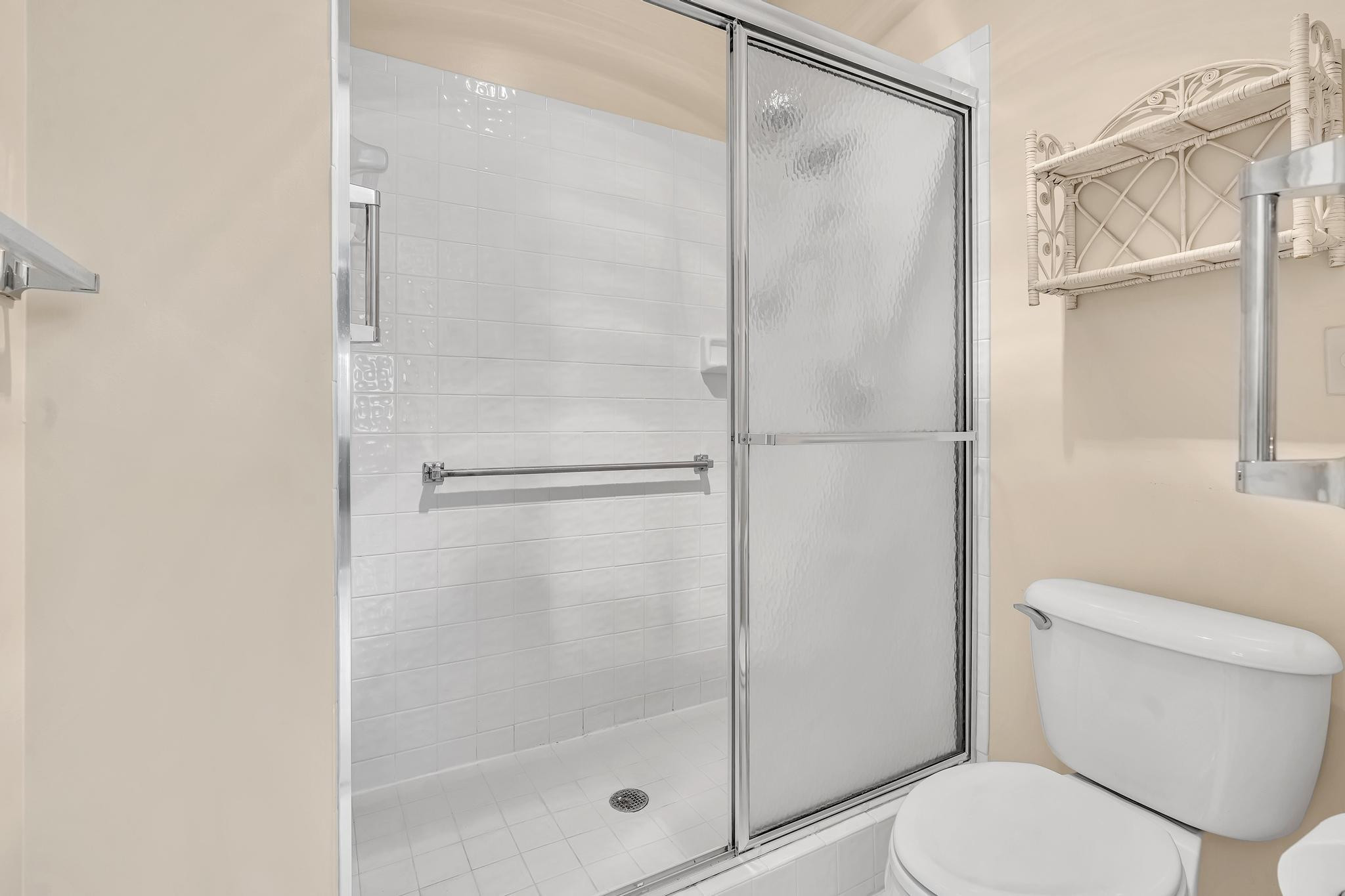 9551 Weldon Circle, Unit E411 Tamarac, FL 33321 - Photo 21 of 78 a bathroom with a shower and a toilet