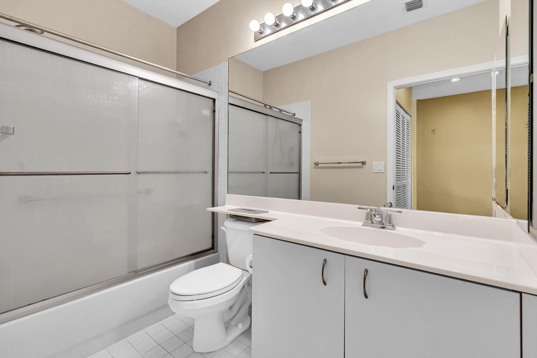 9551 Weldon Circle, Unit E411 Tamarac, FL 33321 - Photo 26 of 78 a bathroom with a sink a toilet and shower