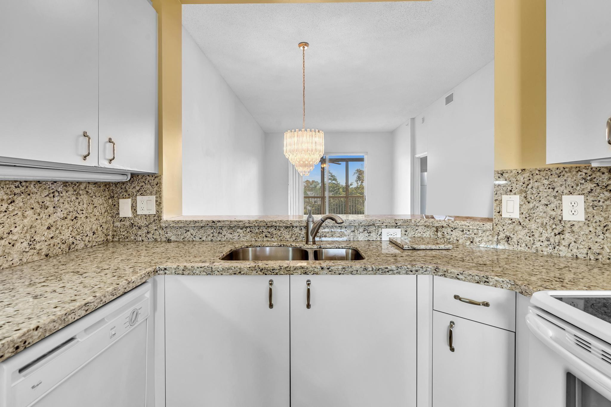 9551 Weldon Circle, Unit E411 Tamarac, FL 33321 - Photo 5 of 78 a bathroom with a granite countertop sink and a mirror