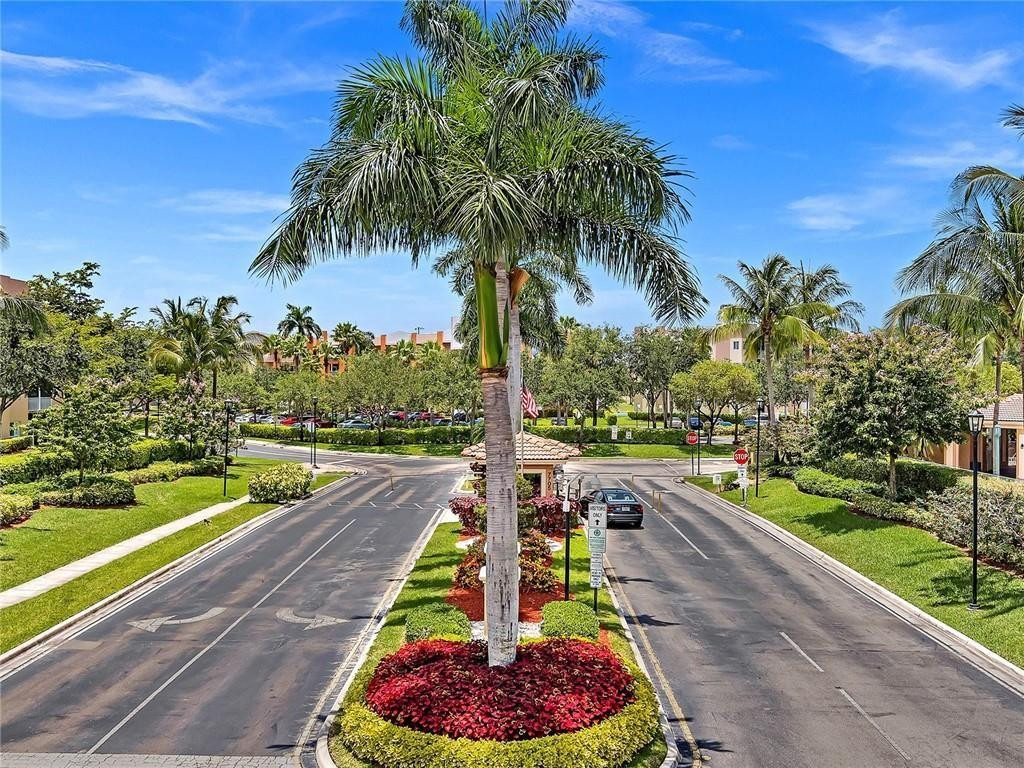 9551 Weldon Circle, Unit E411 Tamarac, FL 33321 - Photo 51 of 78 a swimming pool view with a garden space