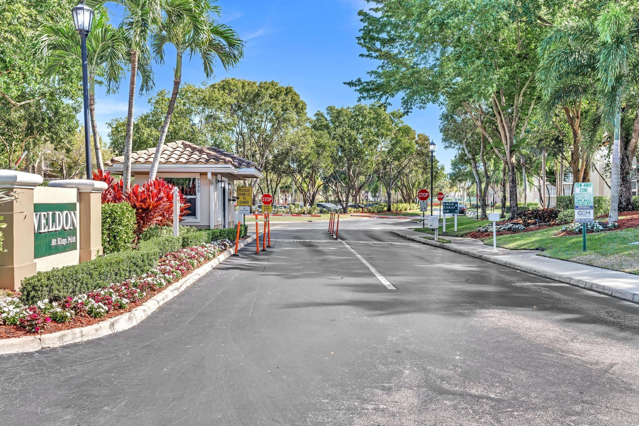 9551 Weldon Circle, Unit E411 Tamarac, FL 33321 - Photo 52 of 78 a view of road with houses and trees