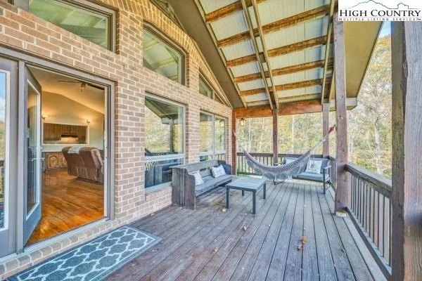 a balcony with furniture and wooden floor