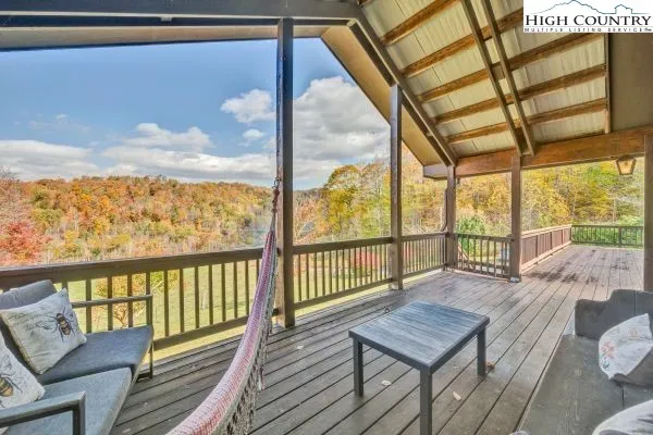 a view of a balcony with furniture and wooden floor
