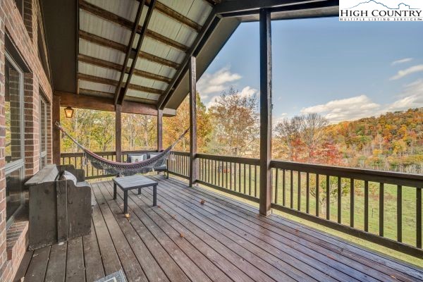 260 Smokey Road Newland, NC 28657 - Photo 16 of 43 a view of a balcony with furniture and wooden floor