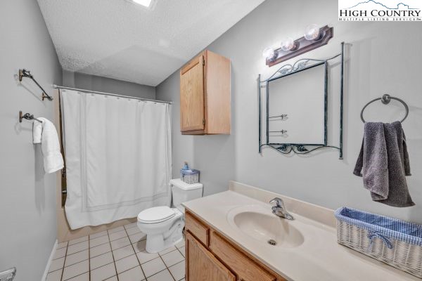 260 Smokey Road Newland, NC 28657 - Photo 21 of 43 a bathroom with a sink a toilet and shower