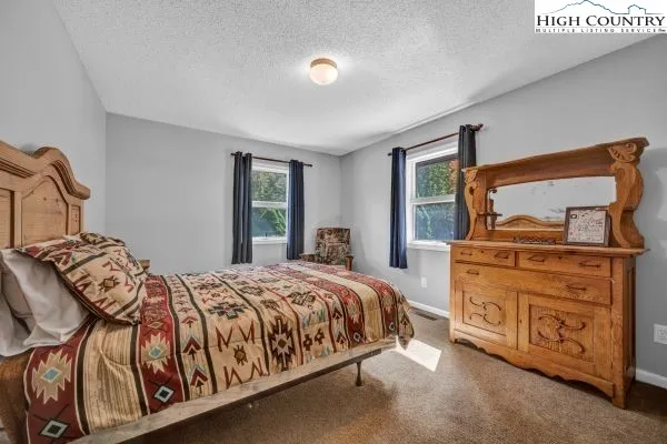 a bedroom with a bed and dresser