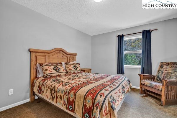 260 Smokey Road Newland, NC 28657 - Photo 27 of 43 a bedroom with a bed and a window