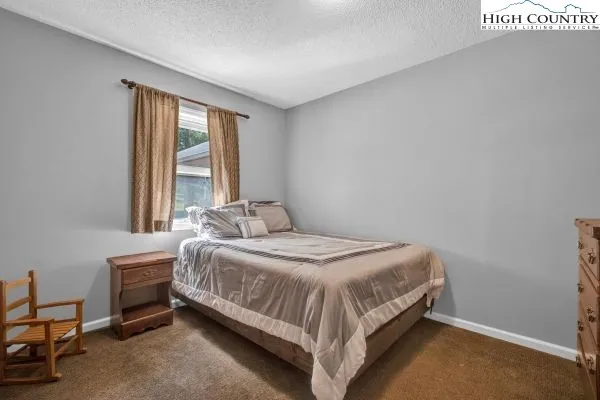 a bed sitting in a bedroom next to a window