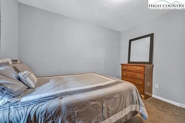 a bedroom with a bed and a mirror