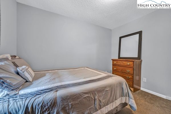 260 Smokey Road Newland, NC 28657 - Photo 29 of 43 a bedroom with a bed and a mirror