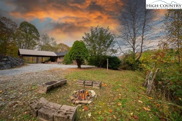 a view of a house with yard and sitting area
