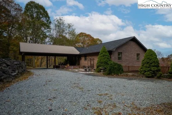 a view of a house with a patio and a yard