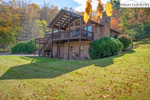 260 Smokey Road Newland, NC 28657 - Photo 38 of 43 a view of a big house with a big yard and large trees