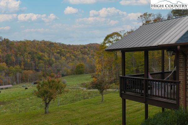 260 Smokey Road Newland, NC 28657 - Photo 42 of 43 a view of a wooden deck that has a table chairs and wooden fence