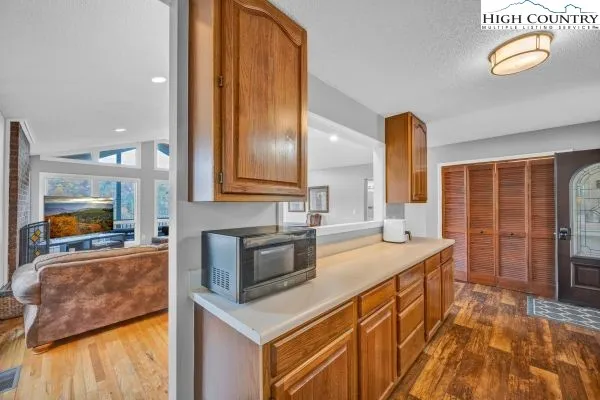 a kitchen with a sink a counter top space and stainless steel appliances