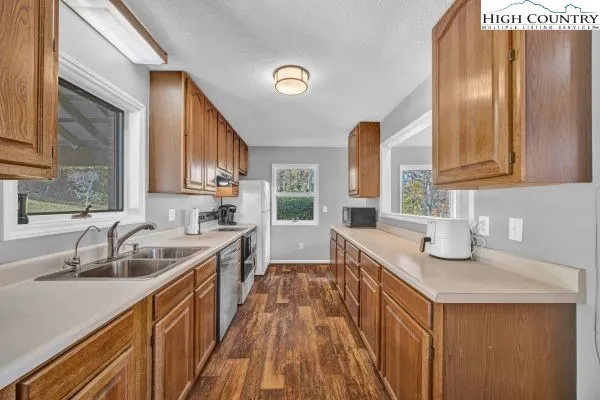 a kitchen with a sink stove and cabinets
