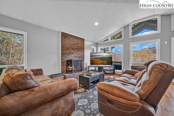 260 Smokey Road Newland, NC 28657 - Photo 9 of 43 a living room with furniture a flat screen tv and a fireplace