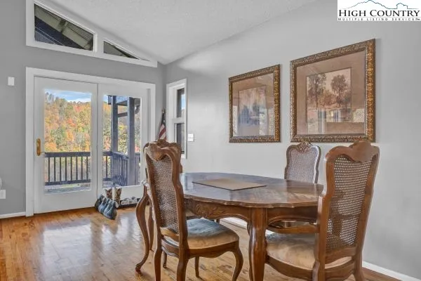 a dining room with furniture and wooden floor