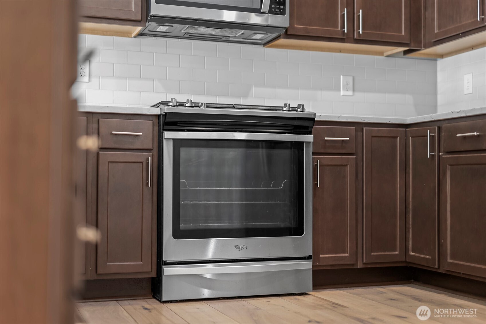 1080 East Old Ranch Road, Unit A1A2 Allyn, WA 98524 - Photo 30 of 35 a stove top oven sitting inside of a kitchen