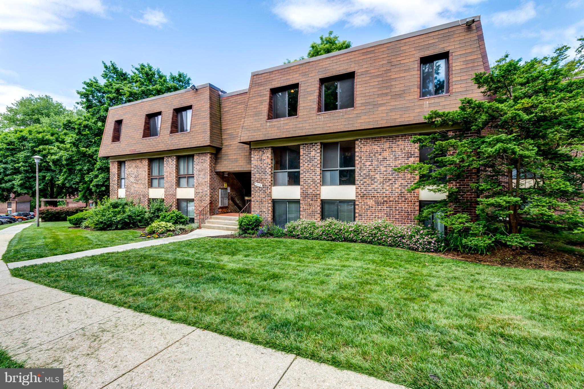 5236 West Running Brook Road, Unit 302 Columbia, MD 21044 - Photo 1 of 25 a front view of a house with a yard