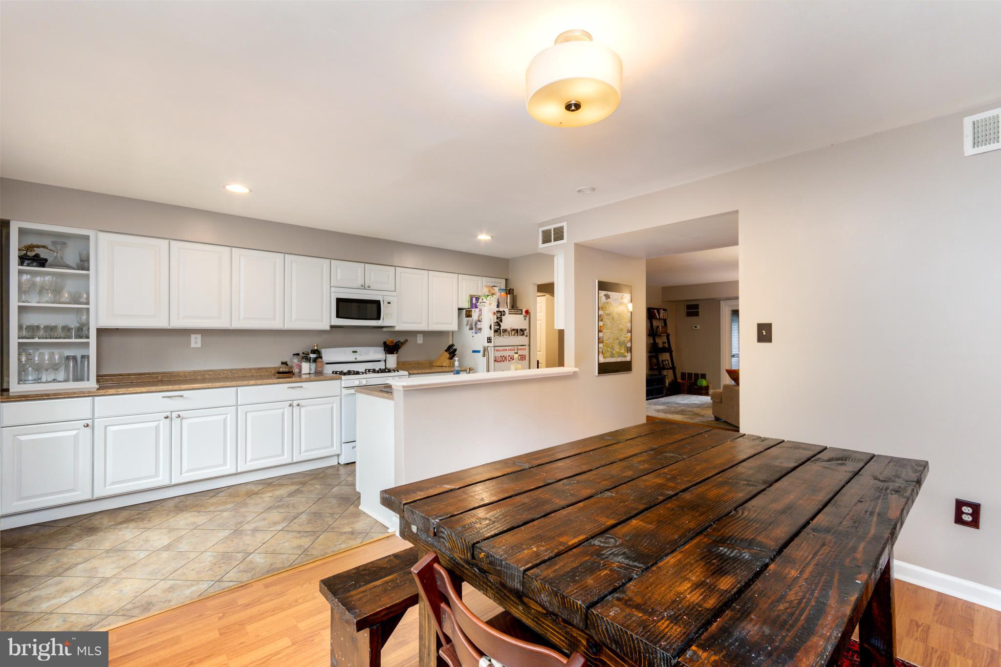 5236 West Running Brook Road, Unit 302 Columbia, MD 21044 - Photo 12 of 25 a kitchen with kitchen island a stove and a refrigerator