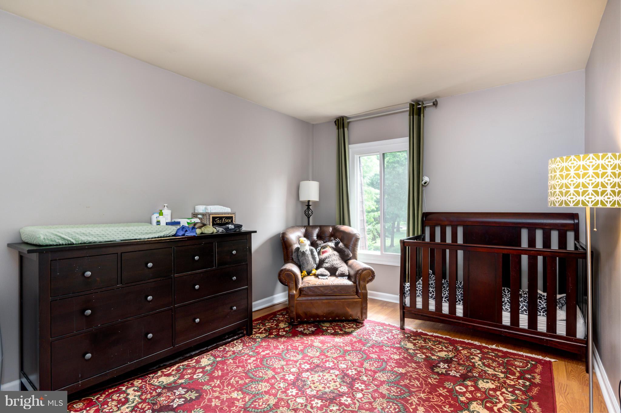 5236 West Running Brook Road, Unit 302 Columbia, MD 21044 - Photo 18 of 25 a bedroom with furniture and a window