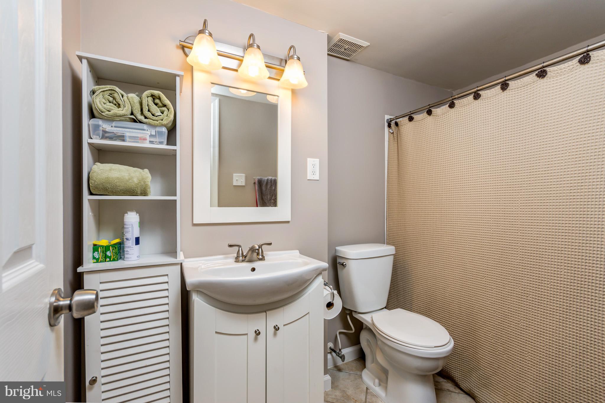 5236 West Running Brook Road, Unit 302 Columbia, MD 21044 - Photo 20 of 25 a bathroom with a toilet sink and mirror
