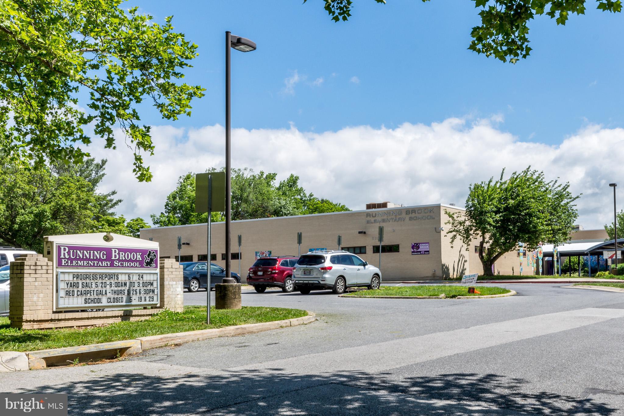 5236 West Running Brook Road, Unit 302 Columbia, MD 21044 - Photo 22 of 25 a front view of a building with garden