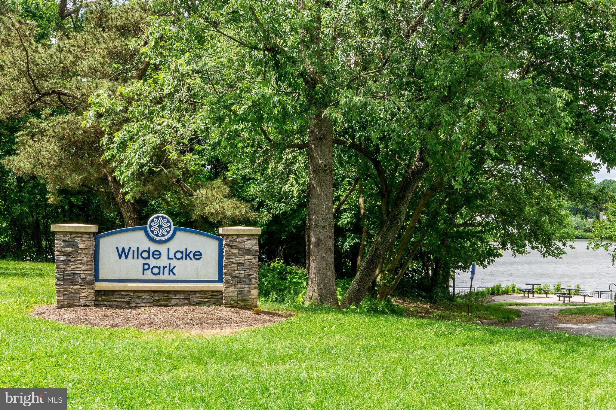 5236 West Running Brook Road, Unit 302 Columbia, MD 21044 - Photo 23 of 25 a sign board with a park bench and trees
