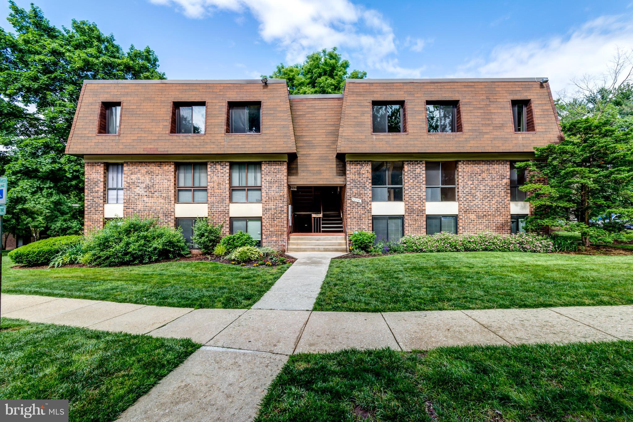 5236 West Running Brook Road, Unit 302 Columbia, MD 21044 - Photo 25 of 25 a front view of a house with a garden
