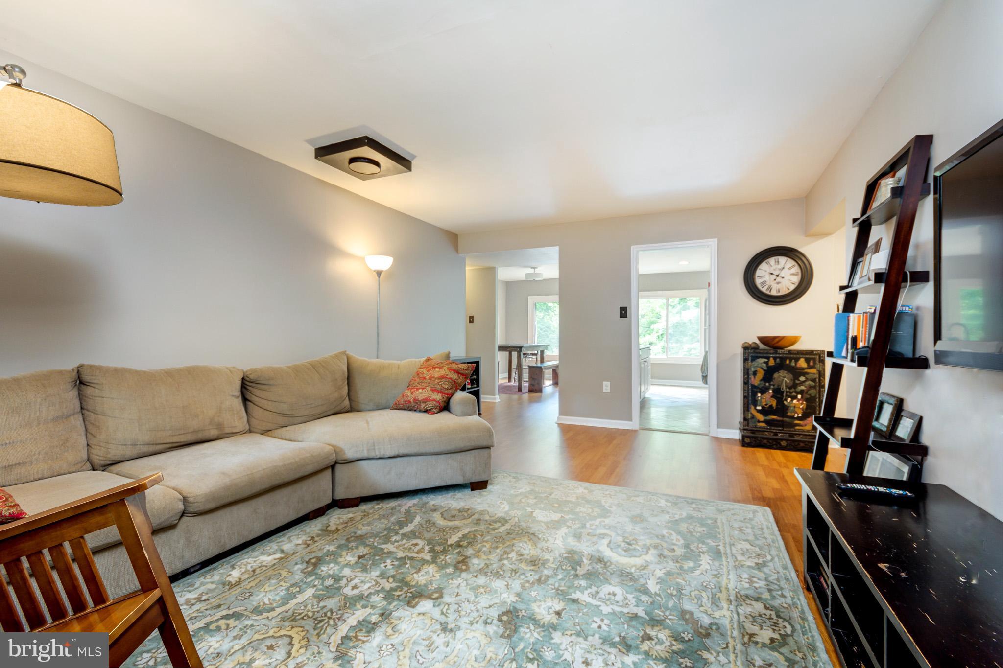 5236 West Running Brook Road, Unit 302 Columbia, MD 21044 - Photo 6 of 25 a living room with furniture and a flat screen tv