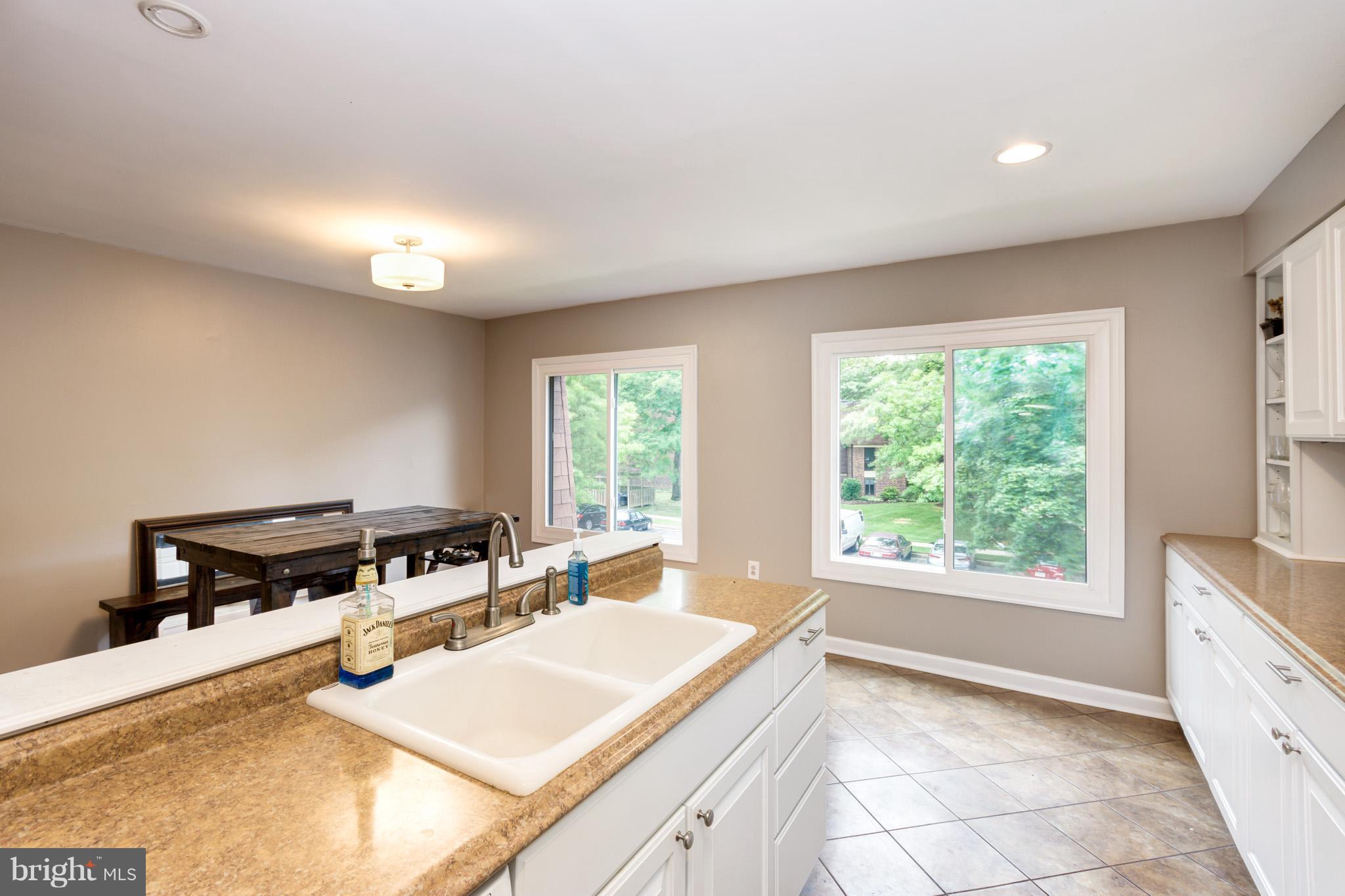 5236 West Running Brook Road, Unit 302 Columbia, MD 21044 - Photo 9 of 25 a view of a kitchen with microwave and windows