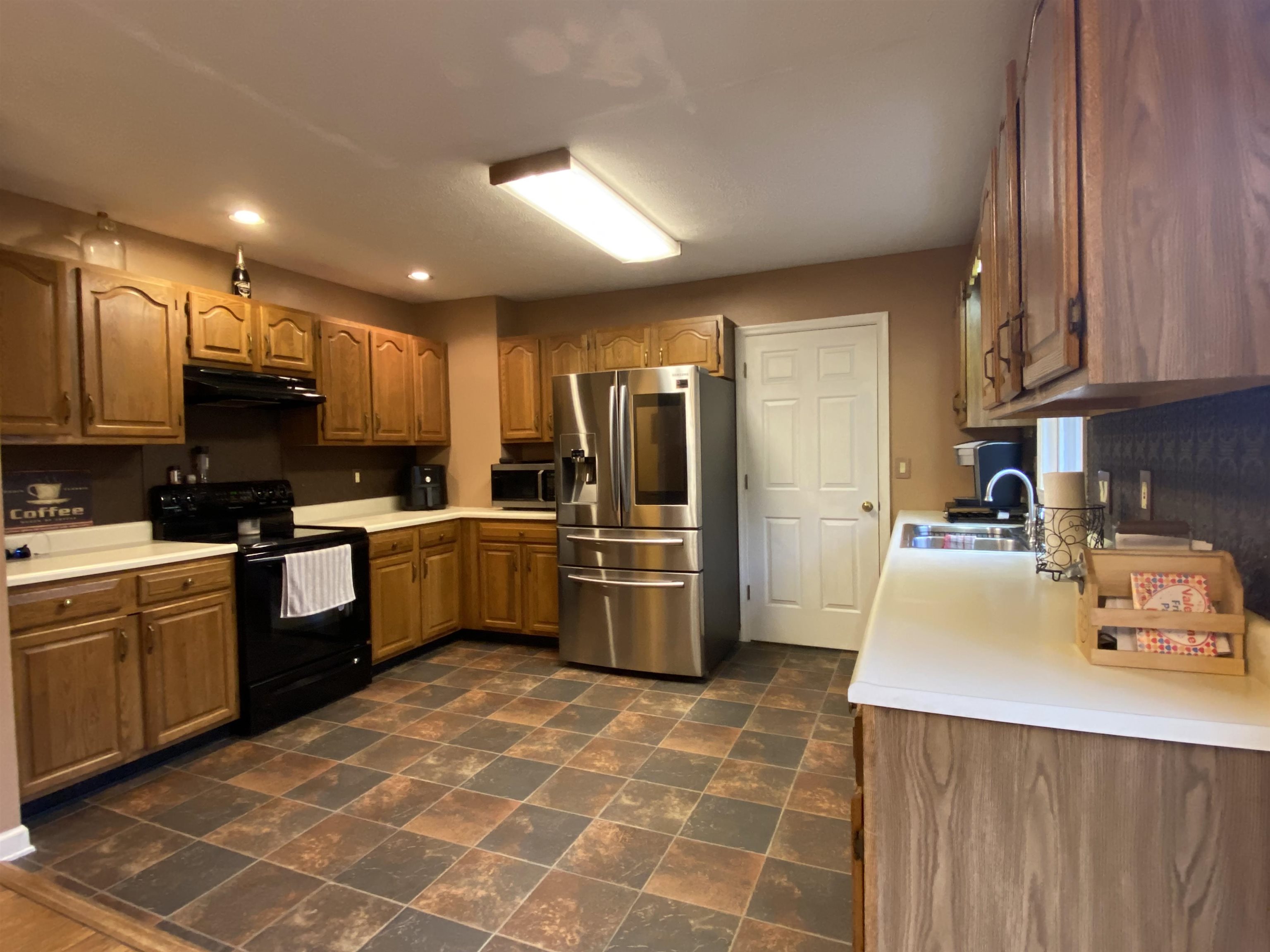 244 Chapel Road Churchville, VA 24421 - Photo 18 of 32 a kitchen with stainless steel appliances a refrigerator sink microwave and cabinets
