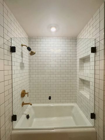 a bathroom with a sink a mirror and shower