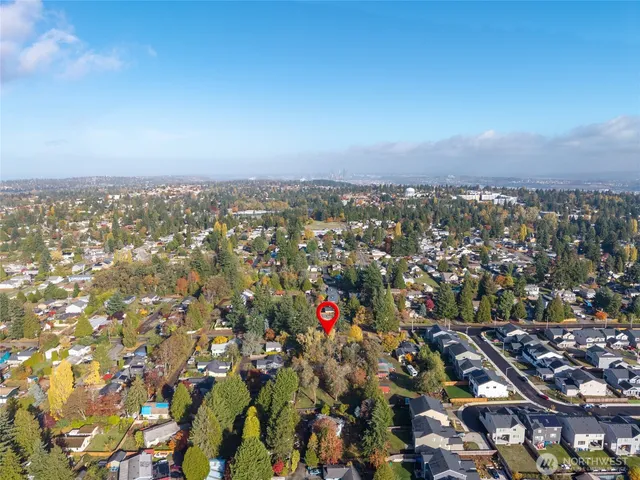a view of a bedroom with wooden floor and windows