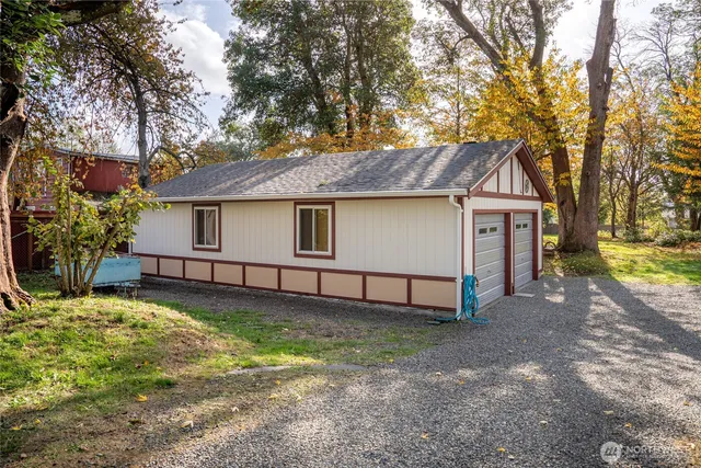 a white house that has a tree in front of it