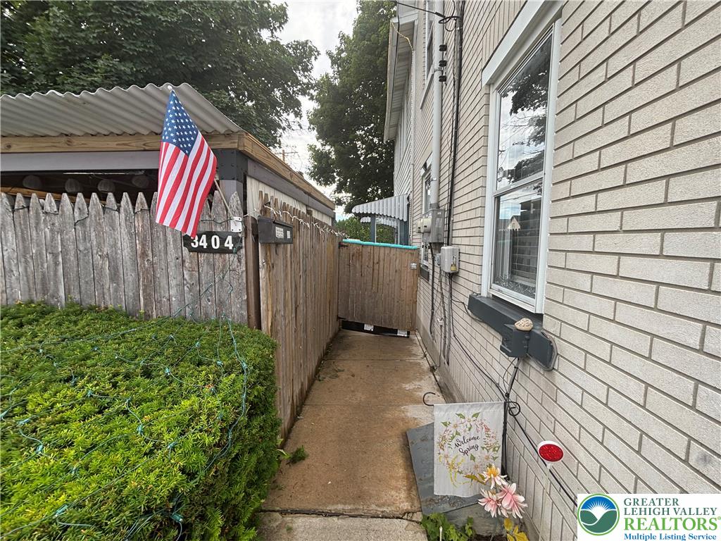 3404 North Ruch Street Whitehall, PA 18052 - Photo 3 of 36 Secure side yard featuring a durable privacy fence and low-maintenance landscaping.